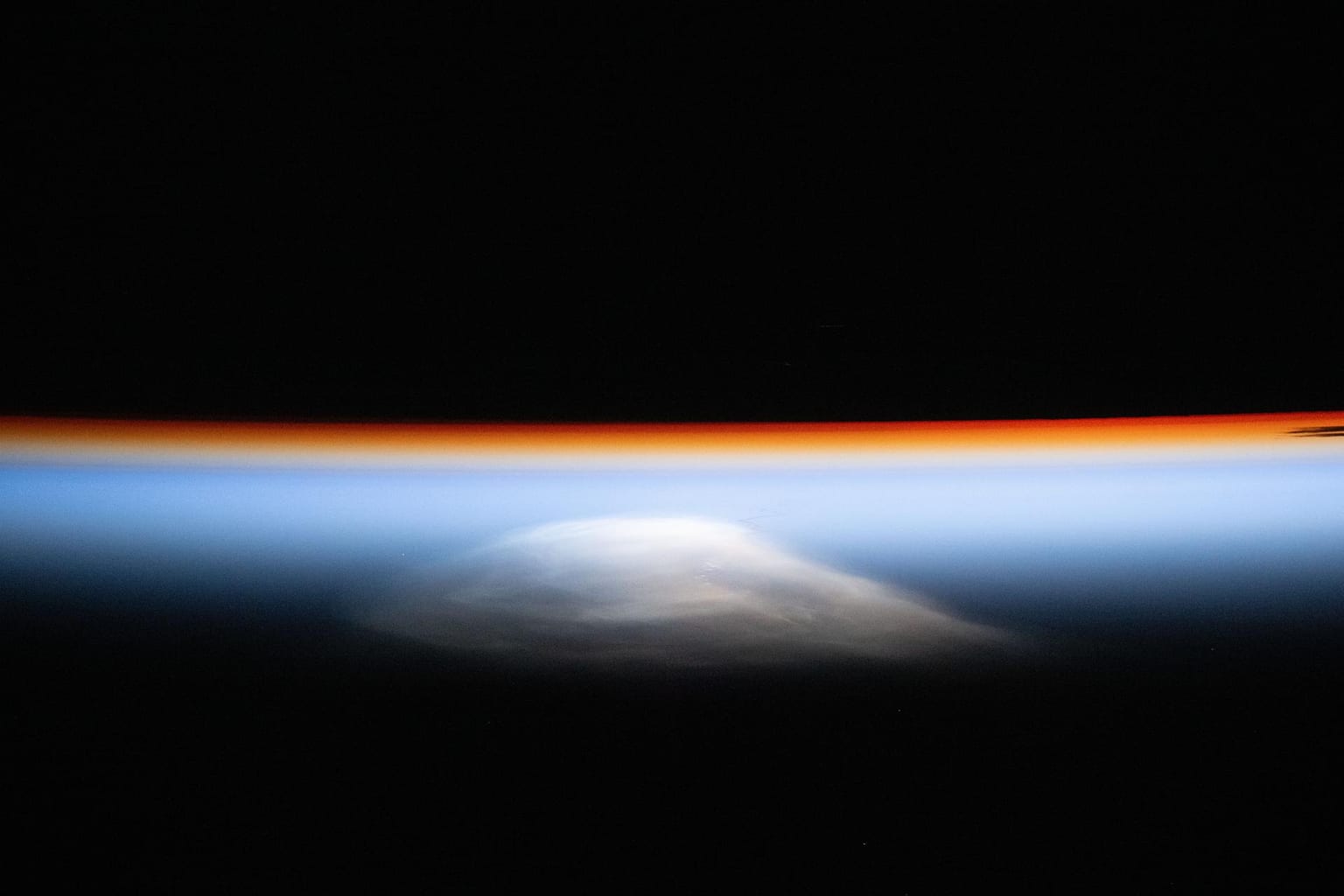 Photo: The last rays of an orbital sunset outline Earth’s horizon
